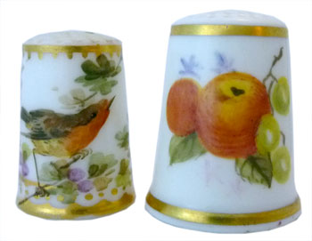 Royal Worcester. Left: Unmarked and unsigned 1870s handpainted robin RW thimble of translucent porcelain. Right: Modern handpainted signed fruit by Joan Rayner. The thimble dates between 1964-1986, when RW ceased making h/p thimbles Royal Worcester. Left: Unmarked and unsigned 1870s handpainted robin RW thimble of translucent porcelain. Right: Modern handpainted signed fruit by Joan Rayner. The thimble dates between 1964-1986, when RW ceased making h/p thimbles