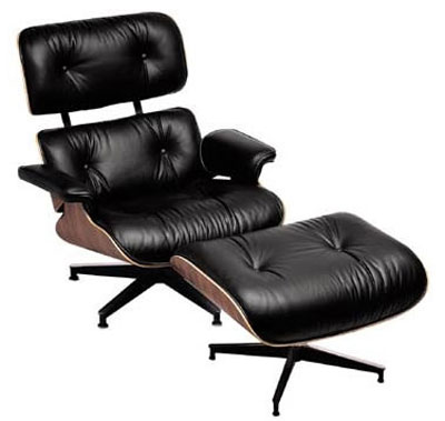 A Ray and Charles Eames walnut and leather 670/671 lounge chair and ottoman. A Ray and Charles Eames walnut and leather 670/671 lounge chair and ottoman.