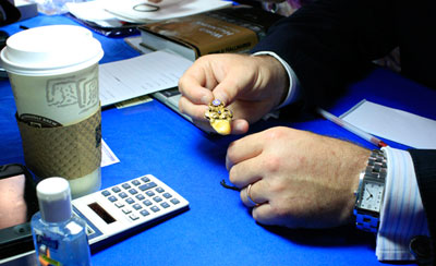 At the Jewelry table, Adam Patrick of A La Vielle Russie, Inc. examines an Elks fob from the early 20th century. The piece is made of 14k yellow gold, includes a diamond and a sapphire, and holds an elk's tooth. It was appraised at $750 to $800. At the Jewelry table, Adam Patrick of A La Vielle Russie, Inc. examines an Elks fob from the early 20th century. The piece is made of 14k yellow gold, includes a diamond and a sapphire, and holds an elk's tooth. It was appraised at $750 to $800.