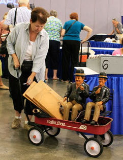 A guest with Laurel and Hardy figures waits to learn how her items will be sorted. That determines which table she'll bring them to once inside. A guest with Laurel and Hardy figures waits to learn how her items will be sorted. This will determine which table she brings them to once inside the Roadshow set.