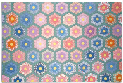 This scalloped-edge quilt from 1928 by Julia Alicia Gobble McMahan features hundreds of hexagons, each of which was hand stitched. TennesseeTSLA-a0a0m3-a_7865