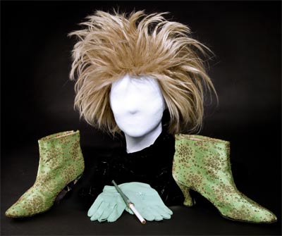 Phyllis Diller donated a fright wig, a pair of shoes, and one of her wooden cigarettes, which she used in her act because the comedienne did not actually smoke. Phyllis Diller's props