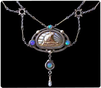 Sailing ship pendant (a ubiqitous motif in Arts & Crafts Jewelry) by the Artificer's Guild. Silver and opals. Note the festoon style chain. Photo courtesy Tadema Gallery, London. Sailing ship pendant (a ubiqitous motif in Arts & Crafts Jewelry) by the Artificer's Guild. Silver and opals. Note the festoon style chain. Photo courtesy Tadema Gallery, London.