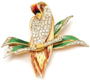 This CoroCraft brooch, circa 1940, uses pavé-set rhinestones to contrast with the feathers and leaves that have been painted on the pin's sterling base. This CoroCraft brooch, circa 1940, uses pavé-set rhinestones to contrast with the feathers and leaves that have been painted on the pin's sterling base.