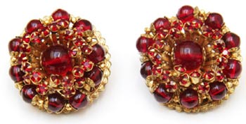 Red beads and rhinestones set in gold filigree make these Miriam Haskell button earrings from the 1950s particularly eye-catching. Red beads and rhinestones set in gold filigree make these Miriam Haskell button earrings from the 1950s particularly eye-catching.