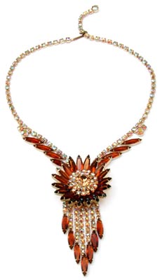 For this bold, sunburst necklace, Juliana designers placed Colorado topaz navette rhinestones around a core of aurora borealis gems, which dates the piece to about 1960. For this bold, sunburst necklace, Juliana designers placed Colorado topaz navette rhinestones around a core of aurora borealis gems, which dates the piece to about 1960.