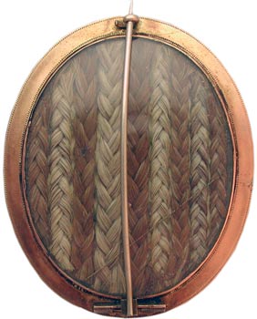 Here, hairwork is found on the back of a brooch, whose front depicts sentimental rather than mourning imagery. Here, hairwork is found on the back of a brooch, whose front depicts sentimental rather than mourning imagery.