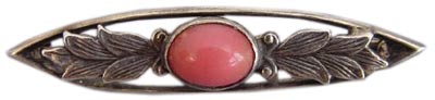 Even during the 1930s, Arts & Crafts designs, such as this bar pin with a coral cabochon and sterling silver leaves, remained popular. Even during the 1930s, Arts & Crafts designs, such as this bar pin with a coral cabochon and sterling silver leaves, remained popular.