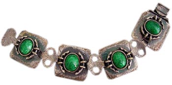 Hammered silver was a favorite of Arts & Crafts jewelers. This silver bracelet is offset by brilliant green enamel centers. Hammered silver was a favorite of Arts & Crafts jewelers. This silver bracelet is offset by brilliant green enamel centers.