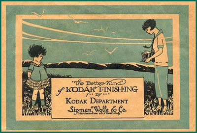 Film wallets were used by photo finishers as sleeves for prints and negatives. This one shows a woman taking a picture of a little girl.