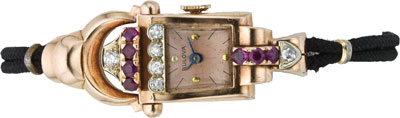 Don't let the plain silk cords fool you: This circa 1940 Bulova is made out of 14K pink gold, real rubies, and half a dozen good-size diamonds. Bulova