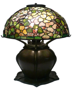 Lamps with bulbous bases were originally made to burn fuel. Later, Tiffany produced electrified versions as well as oil lamps. Some of the oil lamps were converted to electricity. Confetti Dogwood Lamp