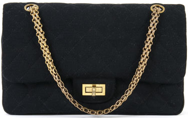 Chanel's black-fabric quilted purses from the 1960s had goldtone straps, a back pocket, double flaps, and a crimson CC-logo lining. A Chanel Black Fabric Quilted Purse, 1960s, with goldtone straps and closure, back pocket, double flaps, fully lined in crimson CC logo lining. Stamped: Chanel.