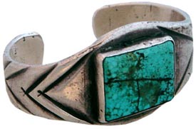 Here's a good example of Navaho chisel-work in hammered ingot silver, circa 1920. The turquoise is from Nevada. Here's a good example of Navaho chisel-work in hammered ingot silver, circa 1920. The turquoise is from Nevada.