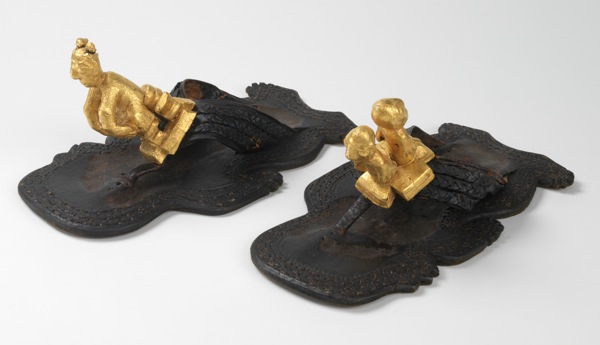 This circa-1930 example from Ghana was worn by the Asantehene of Kumasi and features soles in the shape of human figures and gold-leafed ornaments. This circa-1930 example from Ghana was worn by the Asantehene of Kumasi and features soles in the shape of human figures and gold-leafed ornaments.
