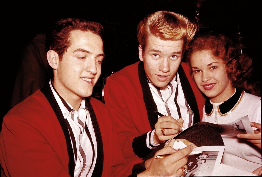 The Casuals In December of 1957, the Casuals were fronted by a couple of 17-year-olds from Nashville named Richard Williams (left) and Buzz Cason (right). Here the young stars sign autographs for fans.