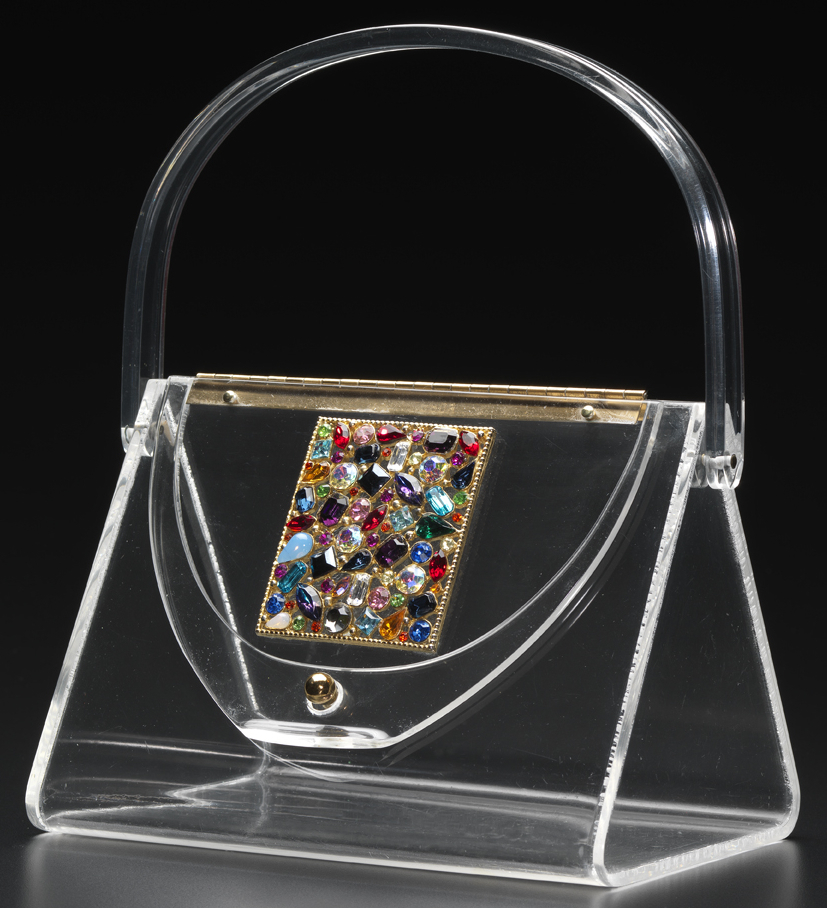 Wilardy Triangle with Rhinestone Plaque In the 1950s, women would change the appearance of their clear Lucite purses by simply changing the scarf they tossed in the bag to hide its contents from view.