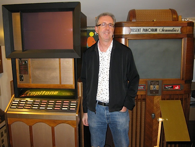 Orlowsky Scopitone film collector Bob Orlowsky poses between a U.S. Scopitone (left) and a Panoram (right), both owned by Dick Hack.
