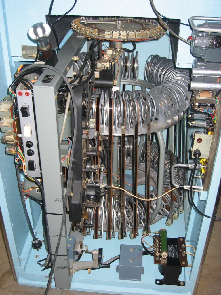 ScopitoneReels The inside workings of a Scopitone machine show how the films were mounted on a carousel, which rotated until the consumer's selection was aligned with the projector.