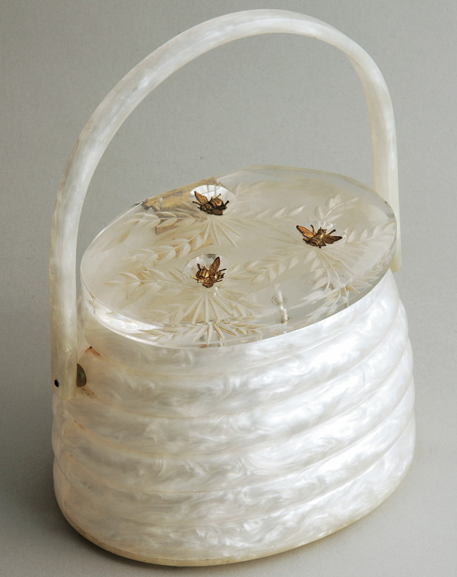 lucite beehive A "Beehive" purse, made by Llewellyn in the 1950s, from Miller's personal collection. With its three brass bees, this Lucite handbag is one of most coveted bags Llewellyn ever made.