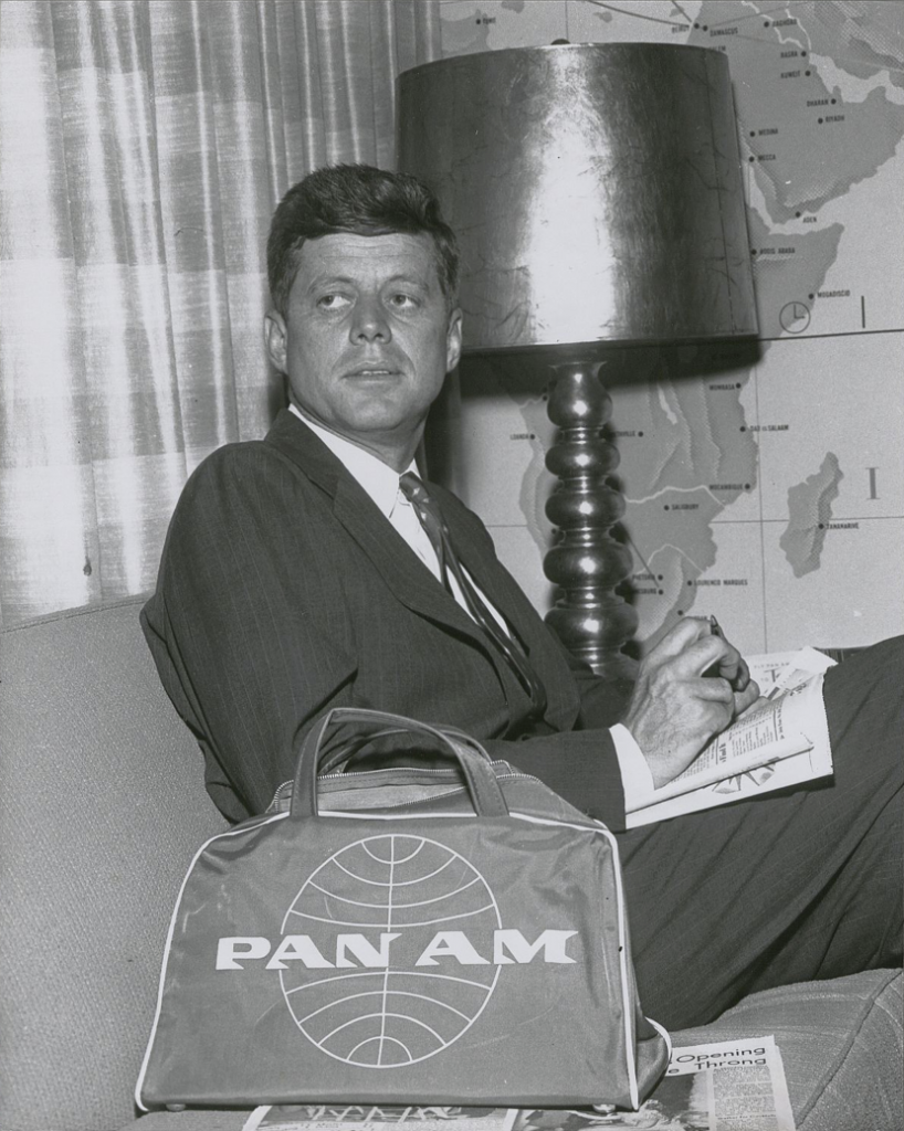 Senator Kennedy Senator John F. Kennedy awaits a flight in the Clipper Club, 1959. Lettering on bags made between 1957 and '62 extended beyond the edge of the globe.