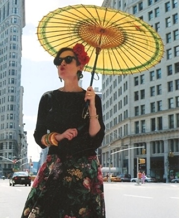 tziporah_21 Salamon gives an air kiss to New York City in a '40s Mexican skirt with nestling Bakelite bracelets on her arm, a '30s flower clip in her hair, and a yellow Chinese parasol.