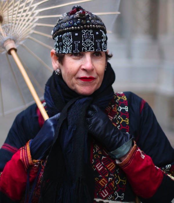 tziporah_4 Salamon wears an Afghani coat with two hats. The small hat on top with the silver amulets is a Bai phoenix hat from the Yunnan Province in China. Ari Seth Cohen took this photo for "Vogue Japan," posted on Advanced Style.