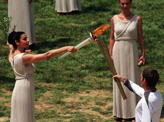 Lighting Ceremony Of The Olympic Flame British-born Greek swimmer Spyros Gianniotis received the flame for the 2012 London Games from the high priestess in Olympia, Greece, on May 10. Via InsidetheGames.biz.