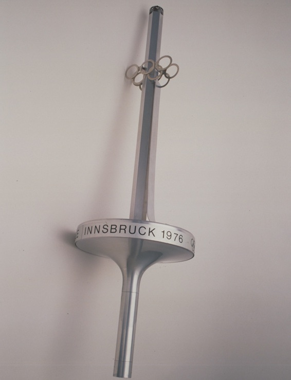 oly_innsbruck The Olympic rings stand out on the sword-style torch for the 1976 Innsbruck Winter Games. Copyright International Olympic Committee.