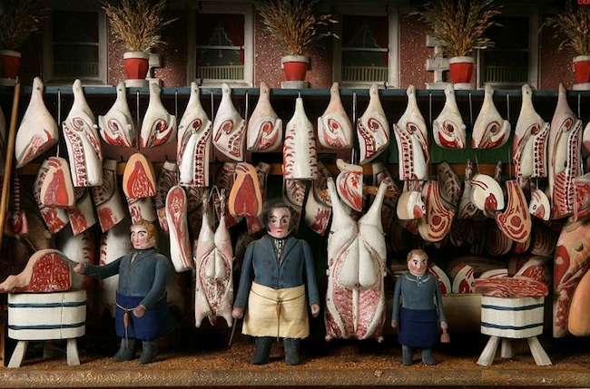 butchershop2 Top: An 1840 model butcher shop, pictured in "The World of Toys," even depicts the blood and sawdust on the floor. Above: The Victoria and Albert Museum has a similar model, circa 1850-'60.