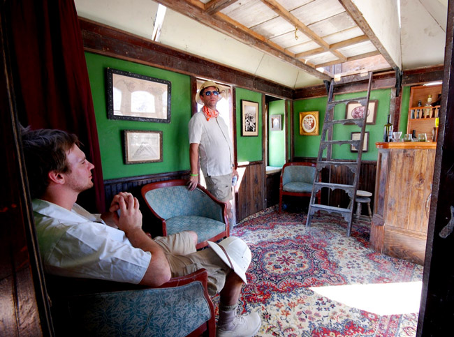 inside Top: The Neverwas Haul in its full glory at Burning Man. Photo by Christopher Michel. Above: Two safari-hatted explorers enjoy the lounge in the Neverwas Haul. Photo by mr science.