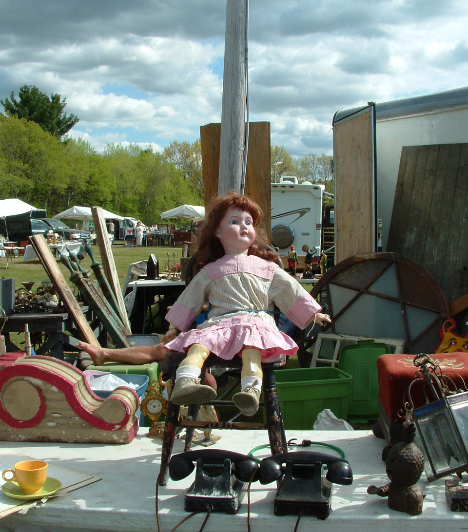 stormydoll A storm brews in the background behind an antique doll at Brimfield Antique Show. Photo by Maureen Stanton.