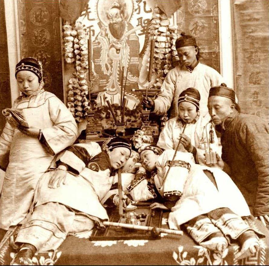 studio card This photo depicting opium smoking was posed in a studio for a stereoview card, circa 1900.