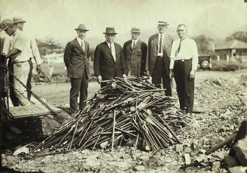 Burning Opium Pipes Confiscated opium pipes in Hawaii are piled up and readied for burning in this photo, circa 1920.