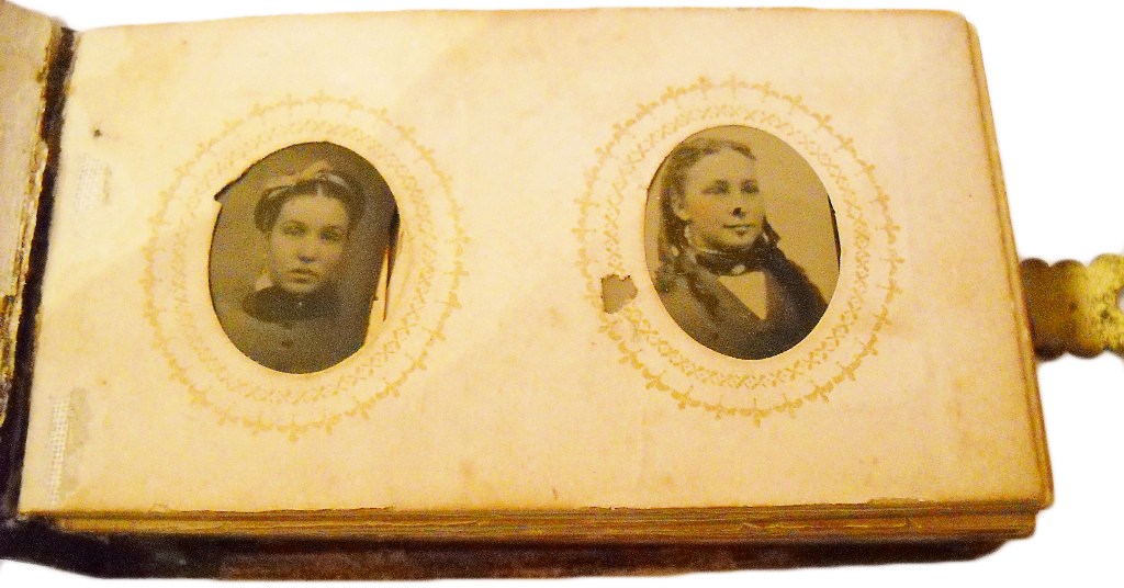 girlsphoto1 The family in this supposedly haunted 1880s tintype photo album is said to have burned to death in a fire.