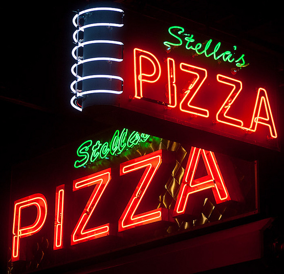 Trimmed Pizza Top: Animated neon advertises the Wonder Wheel ride at Coney Island. Above: Naturally, New York has some great pizza-related neon, like the sign for Stella's in Chelsea. Photos by Hively.