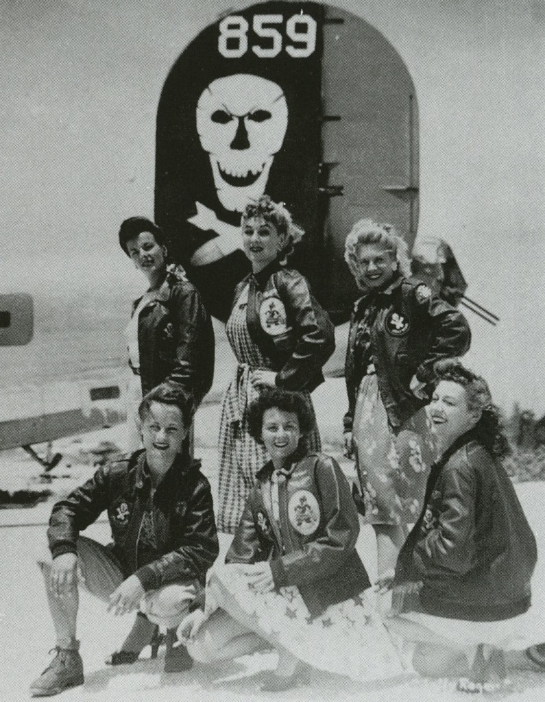 usogirls Six U.S.O. Girls wear A-2 jackets belonging to the 90th Bomb Group, a.k.a. "Jolly Rogers," under a B-24 bomber. From the collection of John Campbell.