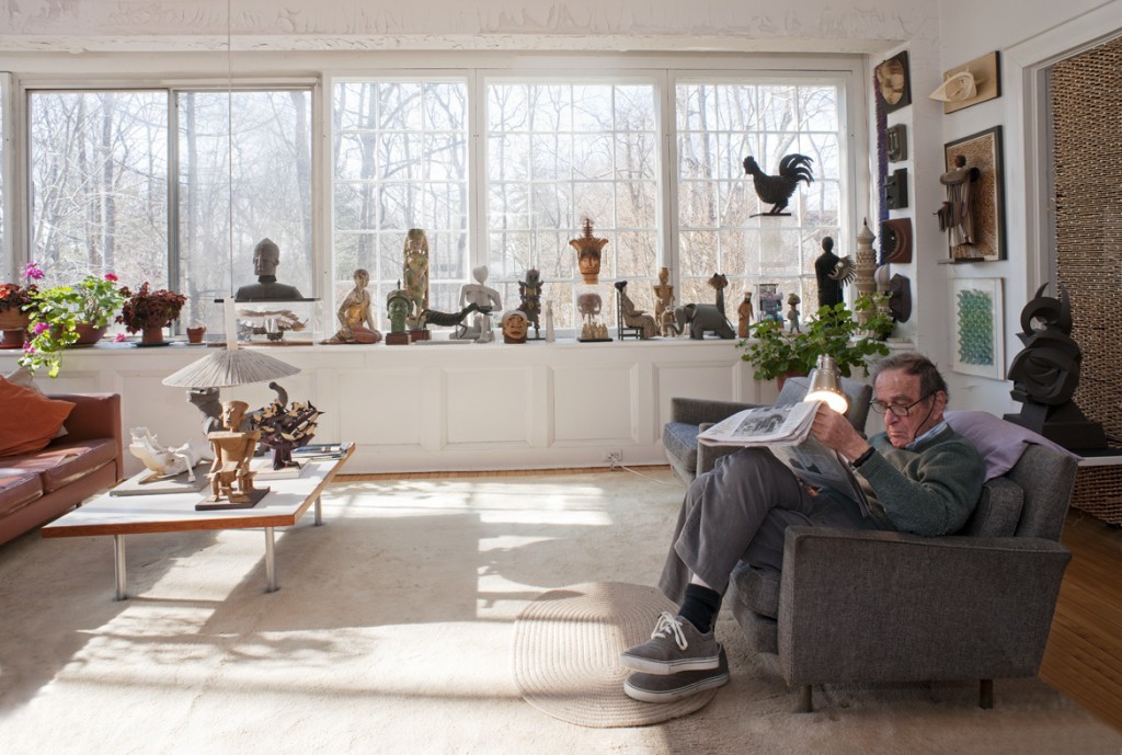 harper_livingroomlarge Harper reads the paper in his living room, surrounded by his own artworks. Photo by Leslie Williamson, from "Irving Harper Works in Paper."