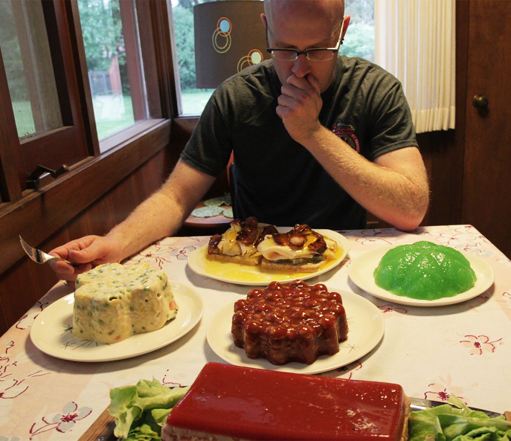 Tom-in-front-of-gelatin-molds-from-our-Glistening-and-Jiggly-Contest Tom in a state of gelatin overload.