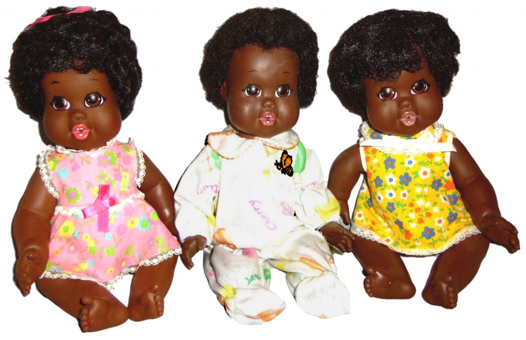 three little girls Top: Jillian Knowles, Samantha's younger sister, sits with their doll collection from childhood in a still from "Why Do You Have Black Dolls?" Above: Three Baby Nancys, the first doll produced by Shindana Toy Company, dedicated to making ethnically correct black dolls, in 1968. Photo by Debbie Behan Garrett.