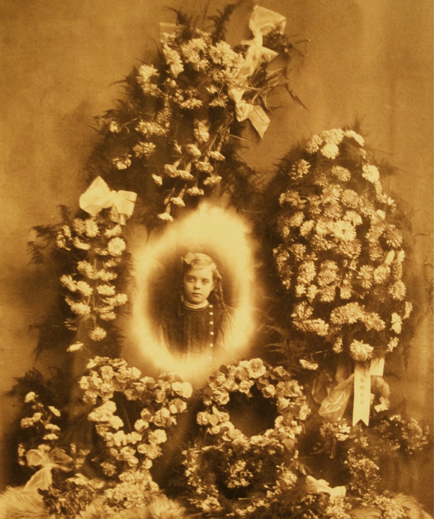 IMG_3075 Early examples of trick photography were used to create funeral tableaus, like image of a young girl collaged onto floral arrangements, circa early 1900s.
