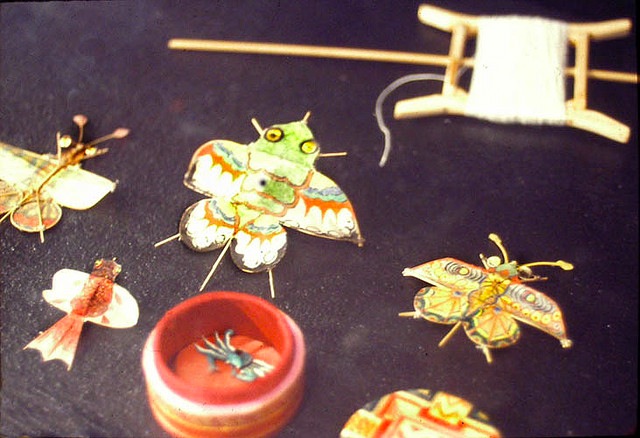 minikites Here are some examples of Chinese miniature kites. The red box, which is the size of a quarter, holds a micro crab kite. Photo by George Peters, via Gallery O.