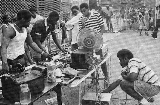 hiphop_koolherc Top: DJ Kool Herc deejays in NYC in 1999. Photo by Mika Väisänen, via WikiCommons. Above: Kool Herc and the Herculoids put on a Bronx party in the 1970s. Via The Flog.