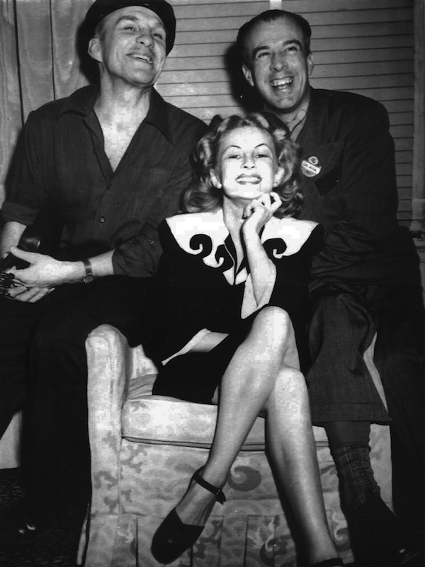 zoe1 Mozert poses with pin-up artists Rolf Armstrong (left) and Earl Moran. All three were among the "Big Four" artists for Brown & Bigelow calendar company. Via "Tease!" #3.