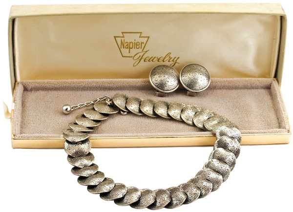 50s_napier80 This early 1950s Napier set, made of silver-plated brass circular discs embossed with a "stars and scrolls" motif, is among Napier's more subdued jewelry. (From "The Napier Co.")