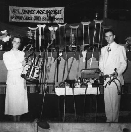 osborns_crutches Daisy and T.L. Osborn pose with crutches, canes, and prosthetics abandoned by people who had been healed. (Via the T.L. Osborn Facebook page)
