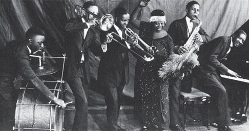 raineyband Ma Rainey, pictured in 1925, and other blues divas of the era usually performed with a backing band. (Via NotesOnTheRoad.com)
