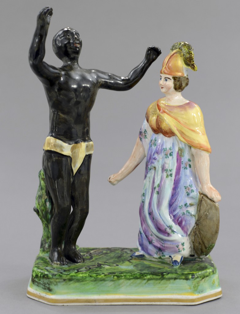 080-005BBB copy A figure commemorating the end of slavery in Britain and its colonies shows a black man celebrating, free of bondage, with Brittania happily observing. Photo © Myrna Schkolne 2013