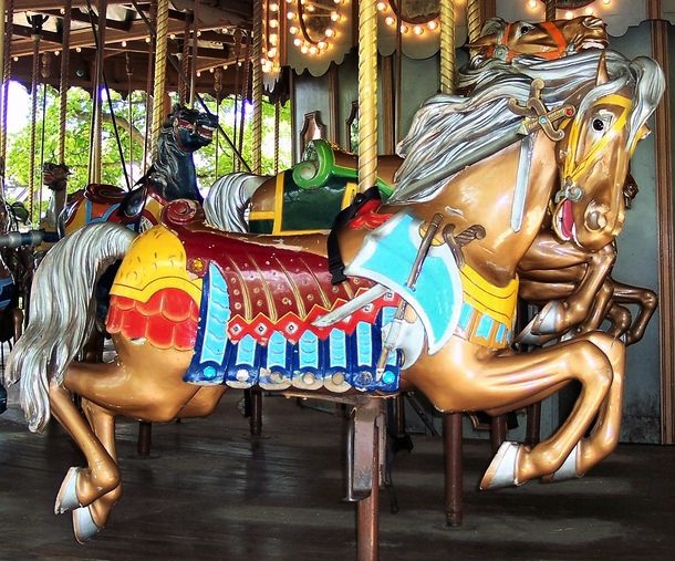 2_PTCstlouis1915 Top: Outside-row animals, like this stander on the 1914 Herschell-Spillman carousel at Golden Gate Park, have the more elaborate carvings than the inside-row animals, especially on the "romance side." (© Aaron Shepard, via carousels.org) Above: This outside-row jumper, a war horse, is a part of the 1915 Grand Ole Carousel at Six Flags St. Louis in Eureka, Missouri, designed by Philadelphia Toboggan Company. (© Bette Sue Gray, both photos via carousels.org)