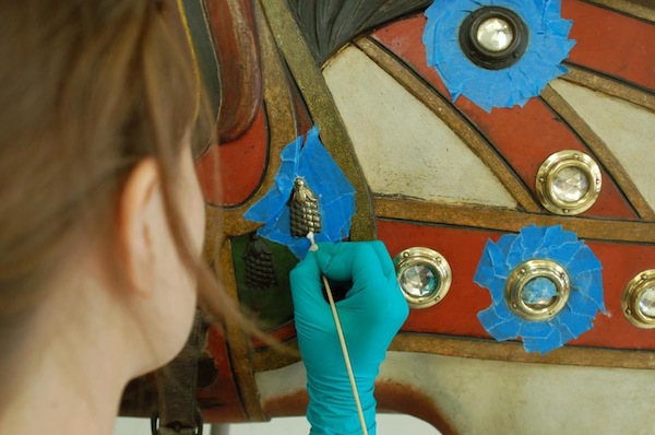 Shelburne A conservation intern at the Shelburne Museum removes linseed oil from a 1906 Dentzel carousel horse. (Via the Shelburne Museum's Dentzel Carousel Facebook page)